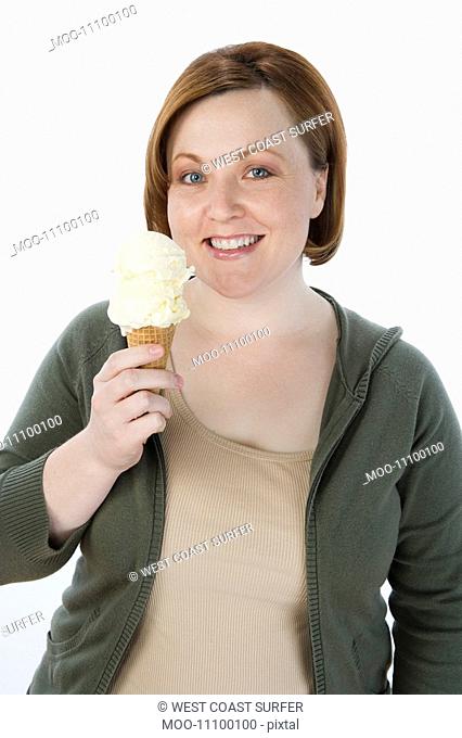 Mid-adult woman holding ice cream cone portrait