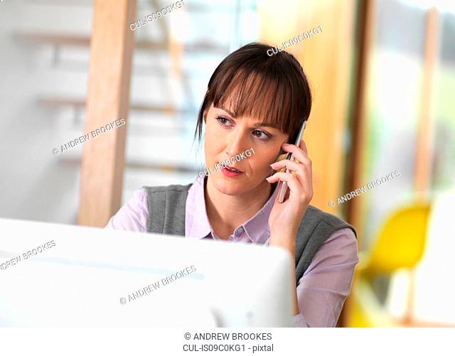Woman talking through a business issue over the phone