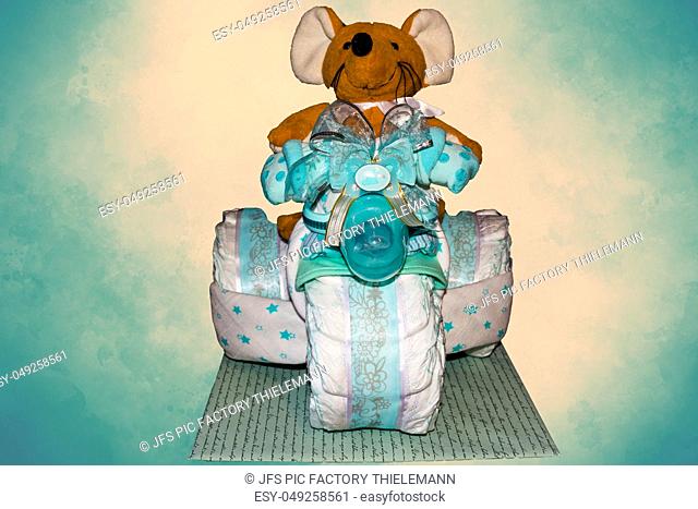 Diaper cake A diaper cake Tricycle with blue ribbons. Gift for the birth of a child