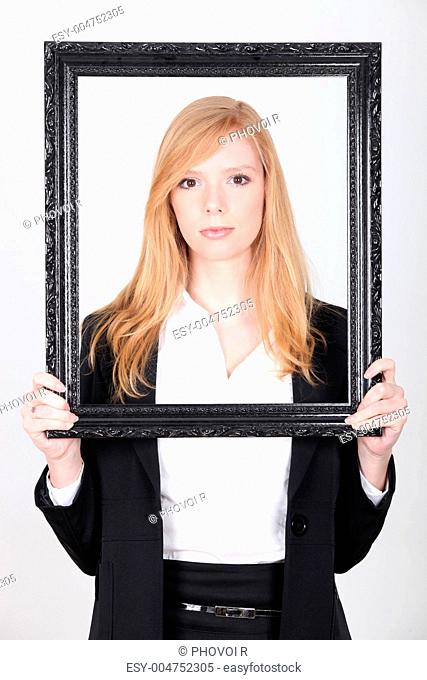 Woman holding up a picture frame