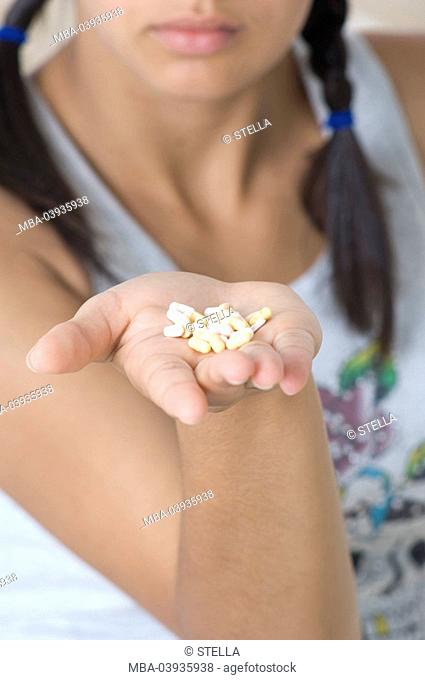 Teenager, palp, pills, detail, hold, blurred