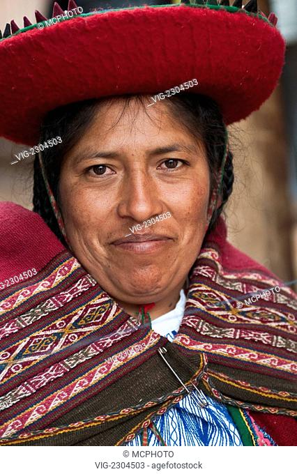 Peru, Chincheros. Peruvian woman in traditional dress at the local artisan coop workshop. - 01/01/2010