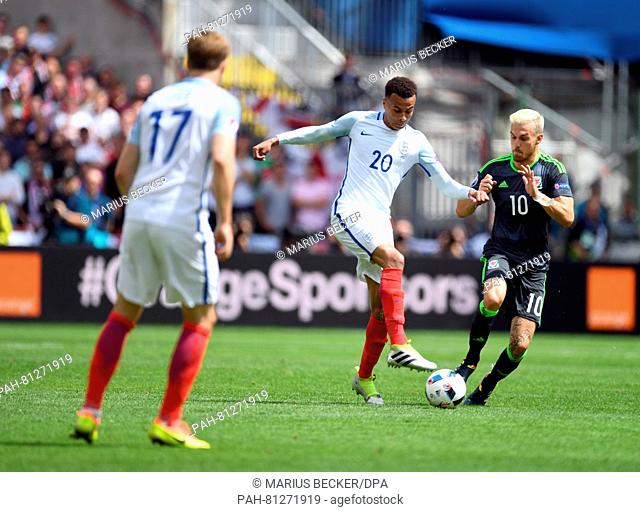 Dele Alli (C) of England and Aaron Ramsey (R) of Wales challenge for the ball during the Euro 2016 Group B soccer match between England and Wales at the Stade...