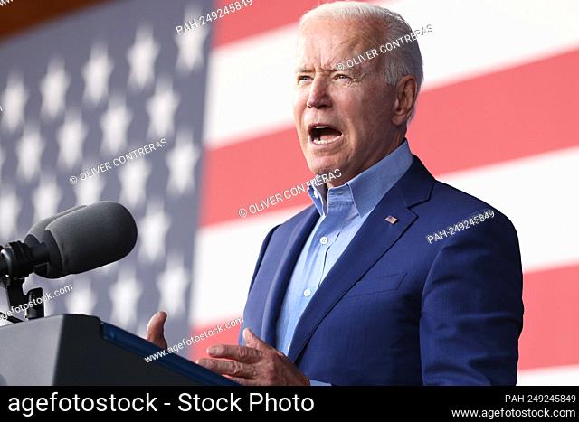 United States President Joe Biden speaks during a campaign event for Virginia gubernatorial candidate Terry McAuliffe, seen here in the background