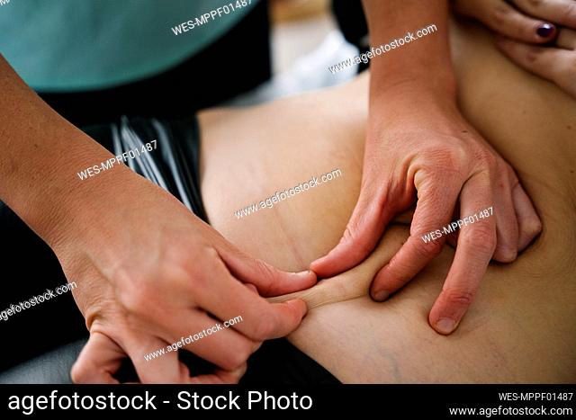 Midwife massaging patient's abdomen