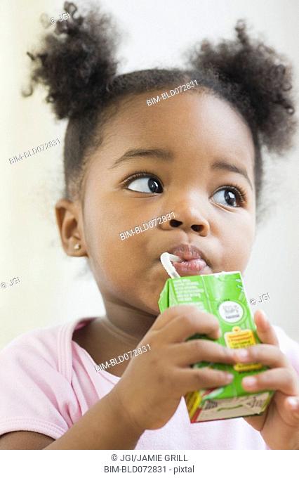 African American girl drinking juicebox