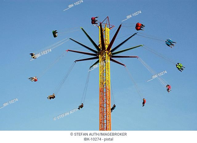 People are flying around high in the sky new chairoplane Octoberfest Munich Bavaria Germany