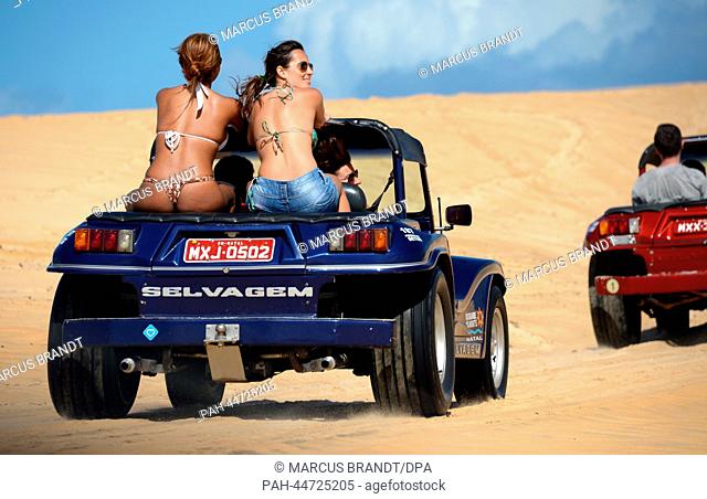 Two female Brazilians enjoy a dune buggy ride in the dunes near Natal, Brazil, 08 December 2013. Photo: MARCUS BRANDT/dpa | usage worldwide