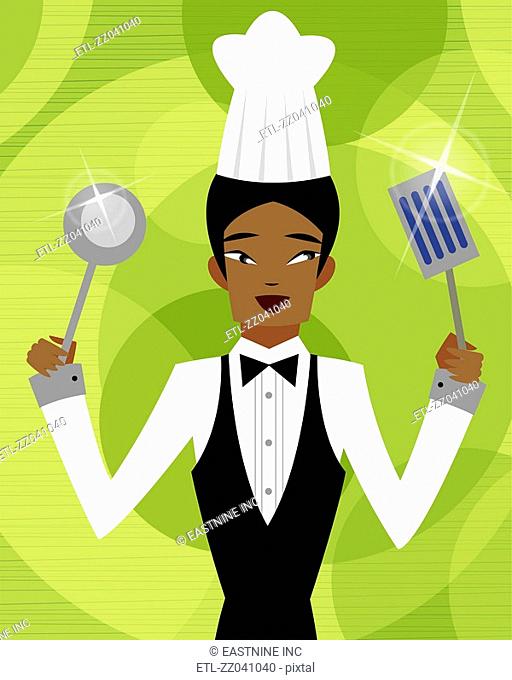 Close-up of a male chef holding a spatula and a ladle