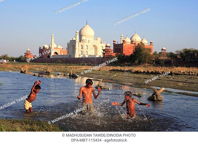 Children playing in Yamuna river at Taj Mahal Seventh Wonders of World , Agra , Uttar Pradesh , India UNESCO World Heritage Site