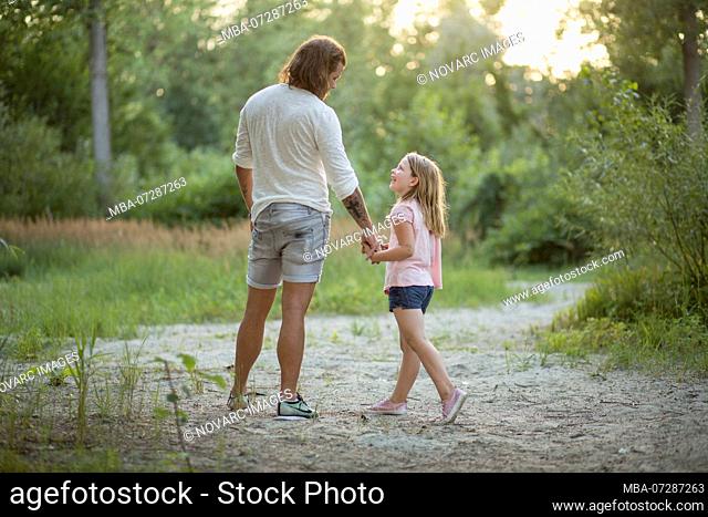 Father and daughter together in the forest
