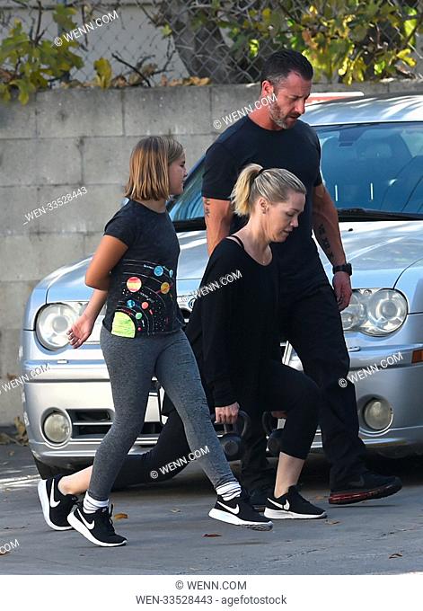 Jennie Garth does lunges with kettle bells with encouragement from her youngest daughter Fiona Eve Facinelli and a trainer Featuring: Jennie Garth