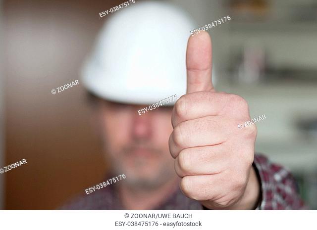 Construction worker showing hand with thumb up