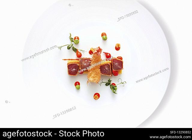 Pink-seared tuna with corn cakes and pastry-wrapped prawns