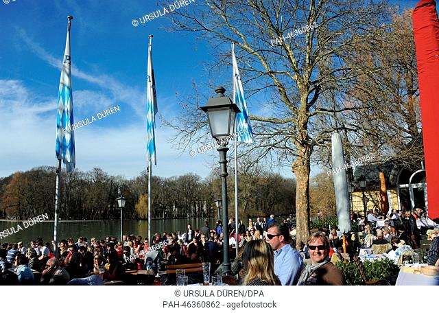 People enjoy the sunny weather on the banks of the Kleinhesseloher Lake in the Englisch Garden in Munich, Germany, 15 February 2014