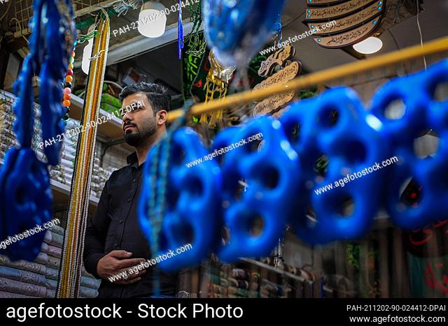 02 December 2021, Iraq, Al-Fariha: An Iraqi vendor stands at the door of his shop where he sells Sebaa Aiyouun (Seven Eyes) amulets in the district of Al-Fariha