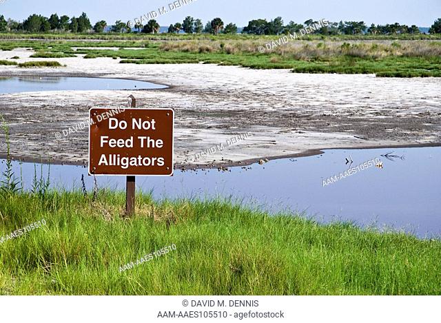 Do not feed alligators sign, Tidal salt marsh, St. Mark's National Wildlife Reserve, FLorida
