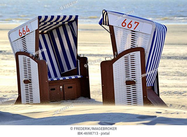 Beach chairs in a sand drift at the northern beach, Norderney, East Frisian Islands, North Sea, Lower Saxony, Germany