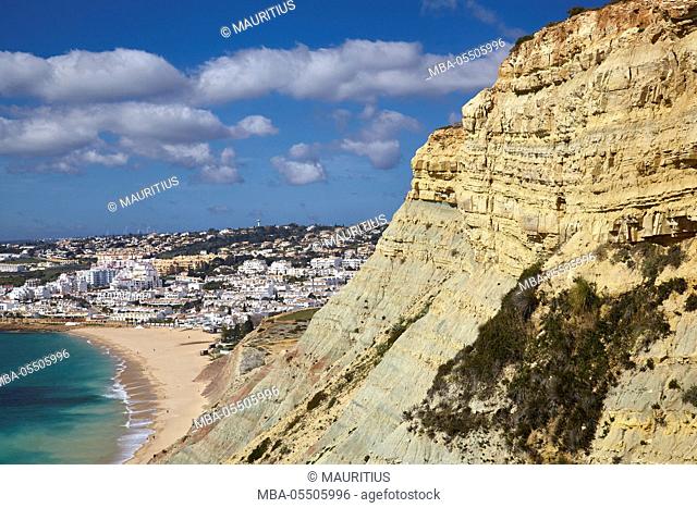 Rock coast at the Atlantic and the small village Luz, west of Lagos, Algarve, Portugal, Europe
