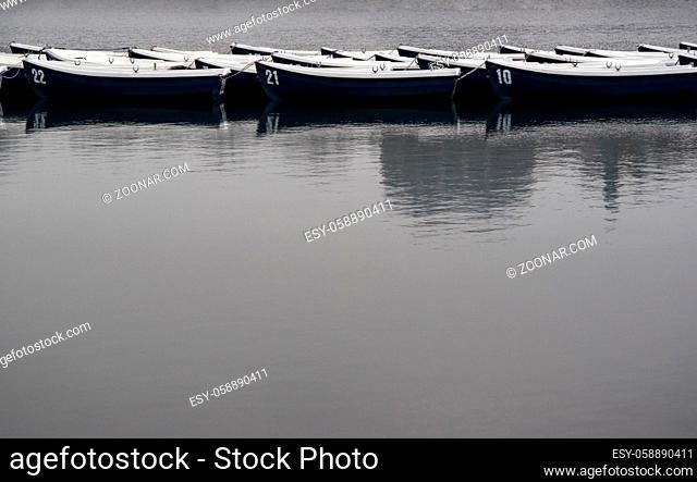 Boats on lake in gray overcast weather