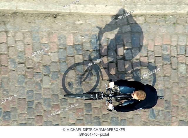 Cyclist with shadow, bird`s eye view