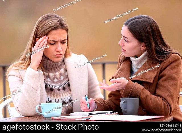 Private teacher teaching to her frustrated student in a terrace