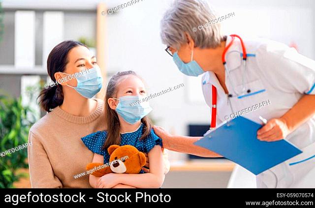 Doctor, child and mother wearing facemasks during coronavirus and flu outbreak. Virus protection. COVID-2019. Taking on masks