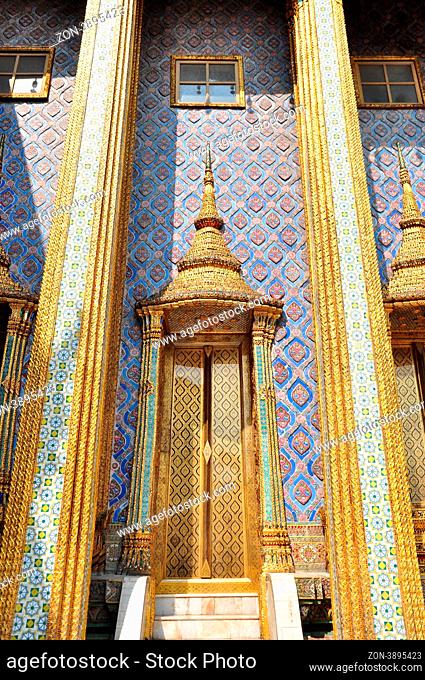 Ancient Golden carving door of Thai temple in Bangkok, Thailand