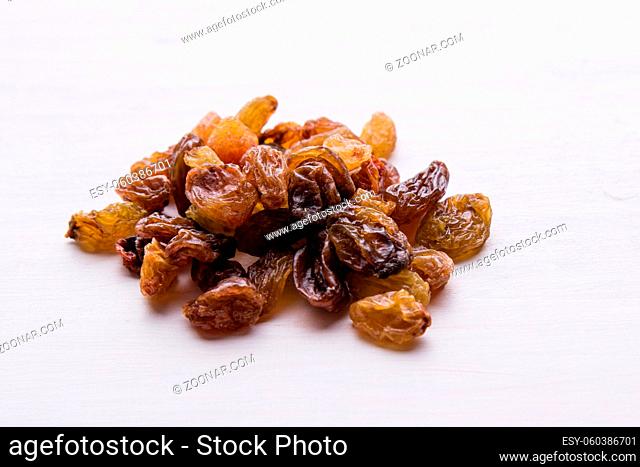 brown healthy sweet raisins on white table