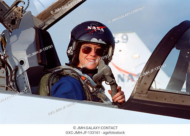 Seated in forward station of a T-38 jet trainer, astronaut Pamela A. Melroy, pilot, is about to fly from Ellington Field to join other STS-92 crew members in...