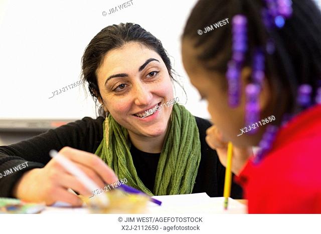 Detroit, Michigan - Third grade teacher Ana Howrani-Heeres helps as her students take a test at Mark Murray Elementary School