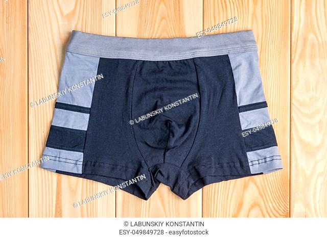 quality cotton panties for boy clothes on wooden boards top view
