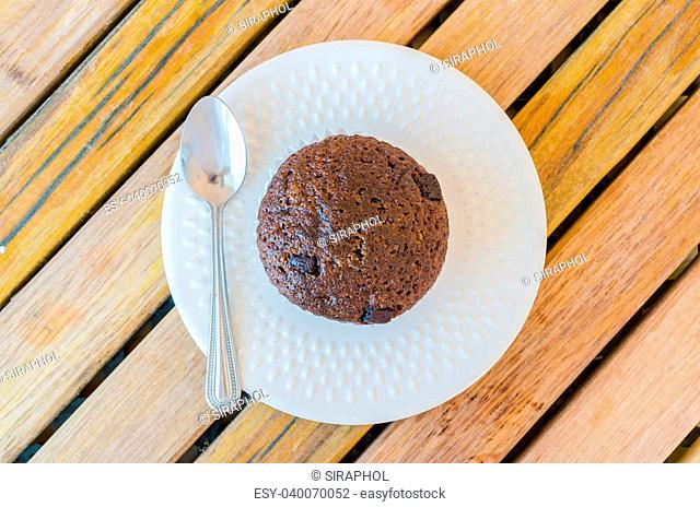 Chocolate banana cupcake in white dish on the wood table