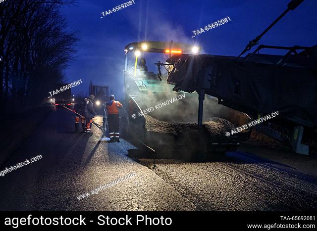 RUSSIA, KHERSON REGION - DECEMBER 12, 2023: Paving asphalt on a road section from the Simferopol – Kherson motorway to the city of Skadovsk