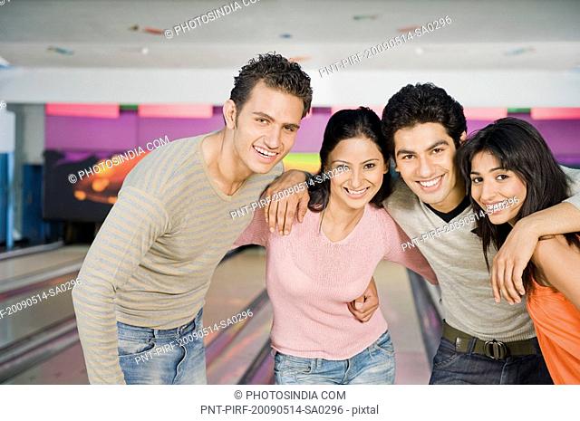 Two young couples in a bowling alley