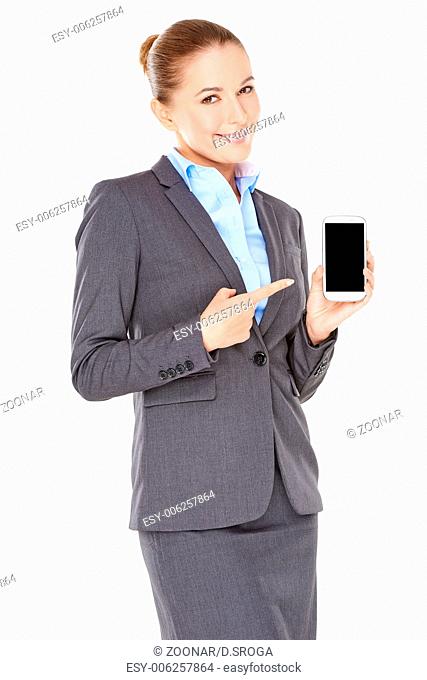 Smiling businesswoman pointing to her mobile