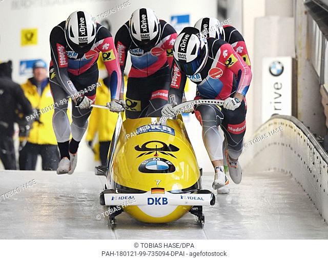 Francesco Friedrich, Candy Bauer, Martin Grothkopp and Thorsten Margis of Germany push their bobsleigh during the 4-man event at the Bobsleigh World Cup in...