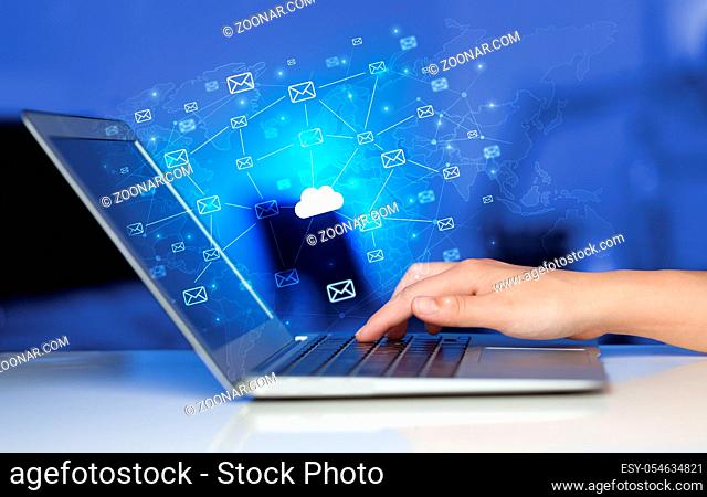 Hand using laptop with cloud computing and online storage concept