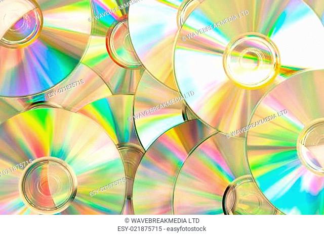 Compact discs piled up with reflection