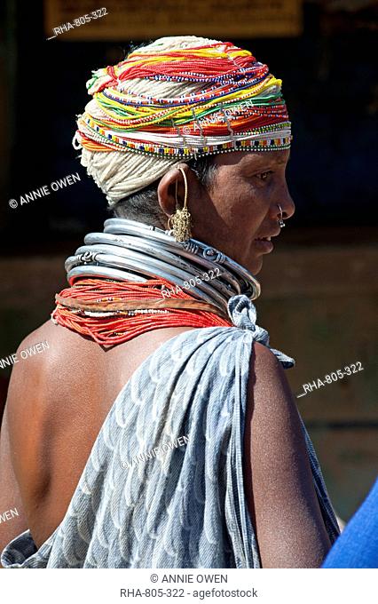 Bonda tribeswoman wearing grey blue cotton shawl and beads with beaded cap, large earrings and metal necklaces at weekly market, Rayagader, Orissa, India, Asia