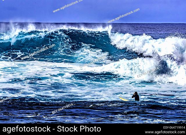 Surfer Looking Large Wave Waimea Bay North Shore Oahu Hawaii. Waimea Bay is famous for big wave surfing. On this day, waves were 15 to 20 feet high