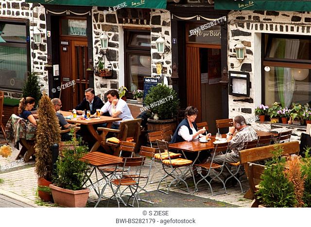people in a sidewalk caf in Altena, Germany, North Rhine-Westphalia, Altena
