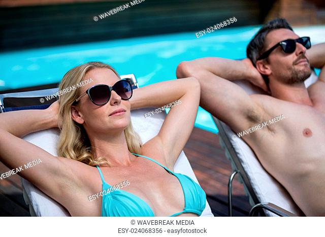 Couple relaxing on a sun lounger
