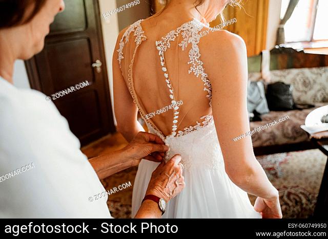 a bride getting ready wearing a dress