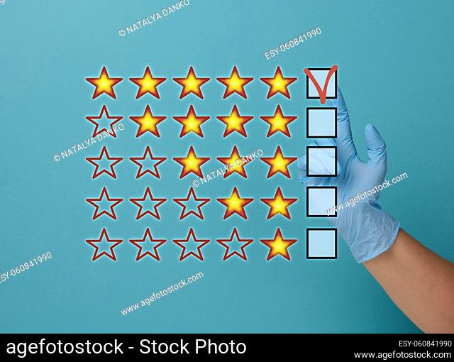 Evaluation and rating concept by voting. Best service and product. Hand in medical latex glove on blue background