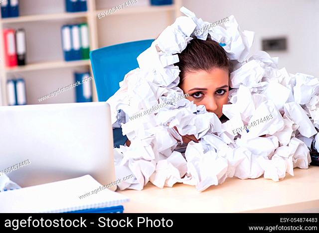 Businesswoman rejecting new ideas with lots of papers