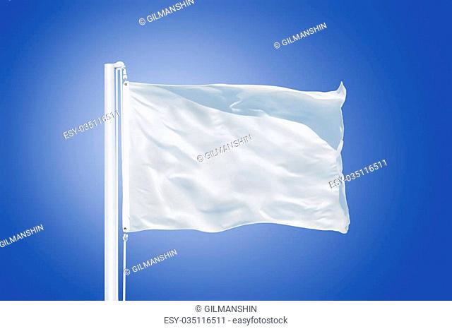 White flag flying in a stiff breeze against clear blue sky