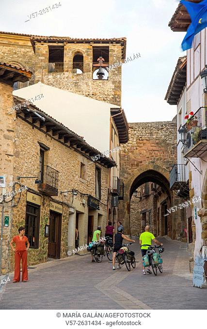 Cyclists walking along the street. España Square, Atienza, Guadalajara province, Castilla La Mancha, Spain