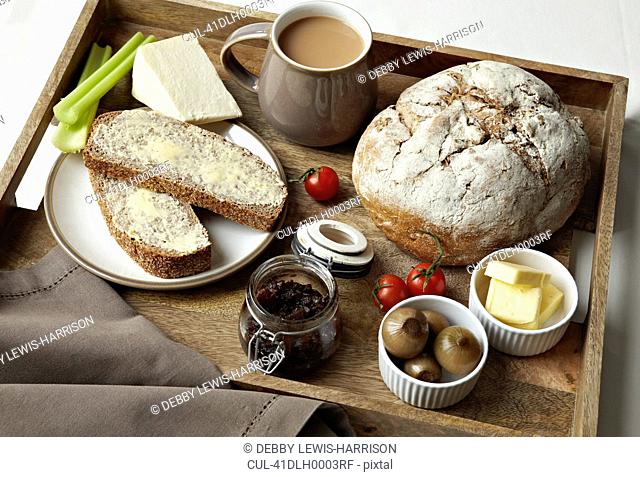 Breakfast tray of bread, jam and coffee