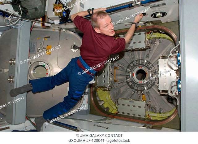 European Space Agency astronaut Frank De Winne, Expedition 21 commander, works near the vestibule between the International Space Station's Harmony node and the...